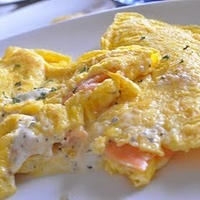 Western-style omelet with smoked salmon and cream cheese into