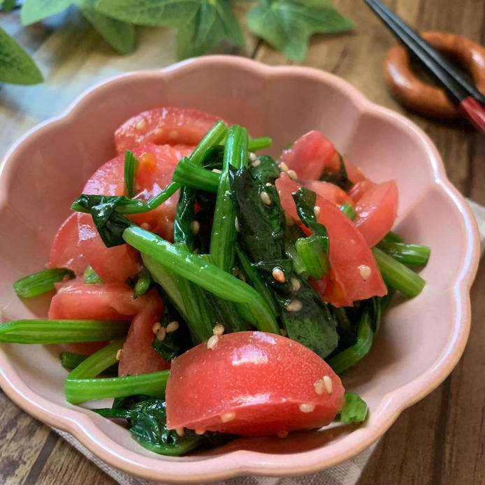 ピンクの器に盛られたほうれん草とトマトの中華和え