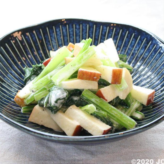 青い皿に盛られた小松菜とりんごのサラダ