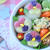 カラフルイモ持ちのキャラ弁～すみれのお花のお弁当～
